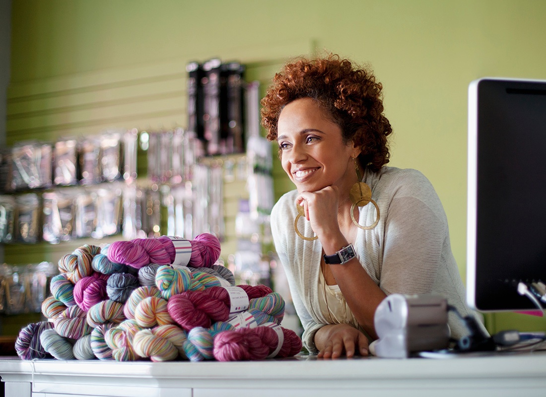 Business Insurance - Yarn Shop Owner Happily Waits For Customers